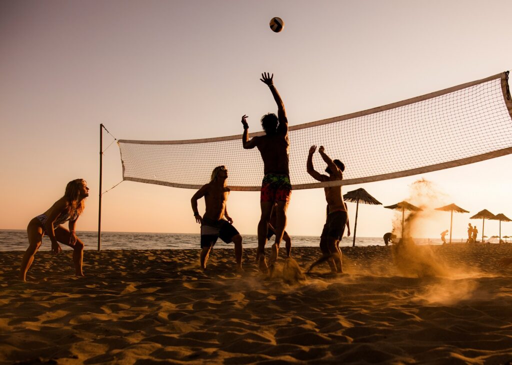 Playing volleyball on the beach at sunset! content-image